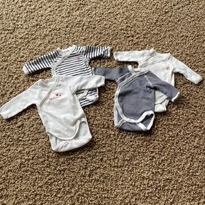 Four gently used Petit Bateau Newborn onesies
